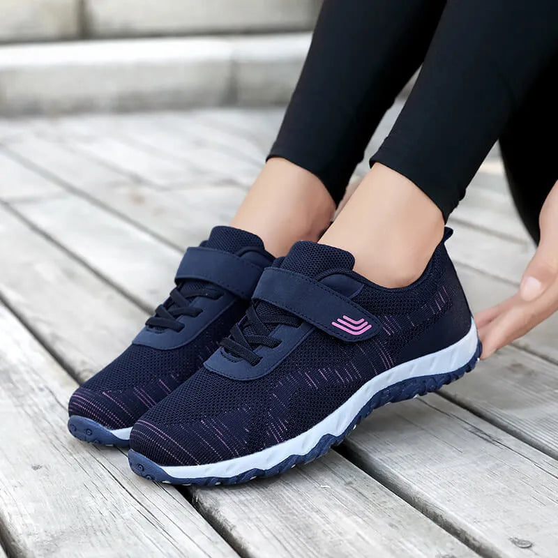 Women's grey purple wedge shoes with Velcro strap and mesh upper on a composite sole.