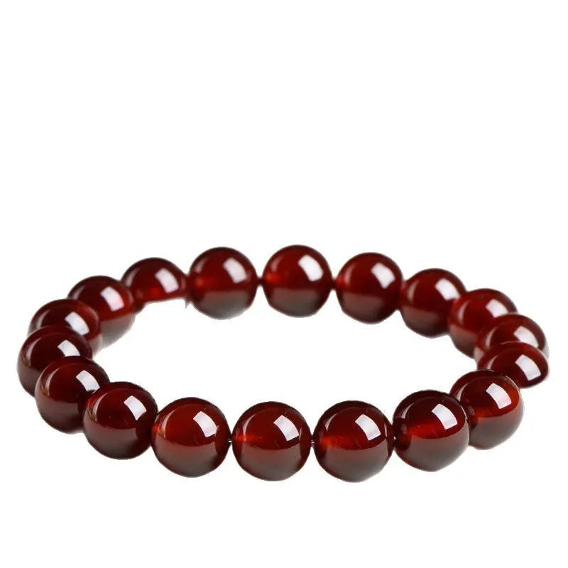 Natural orange red garnet ball bracelet with ruyi element in retro unisex design on wrist