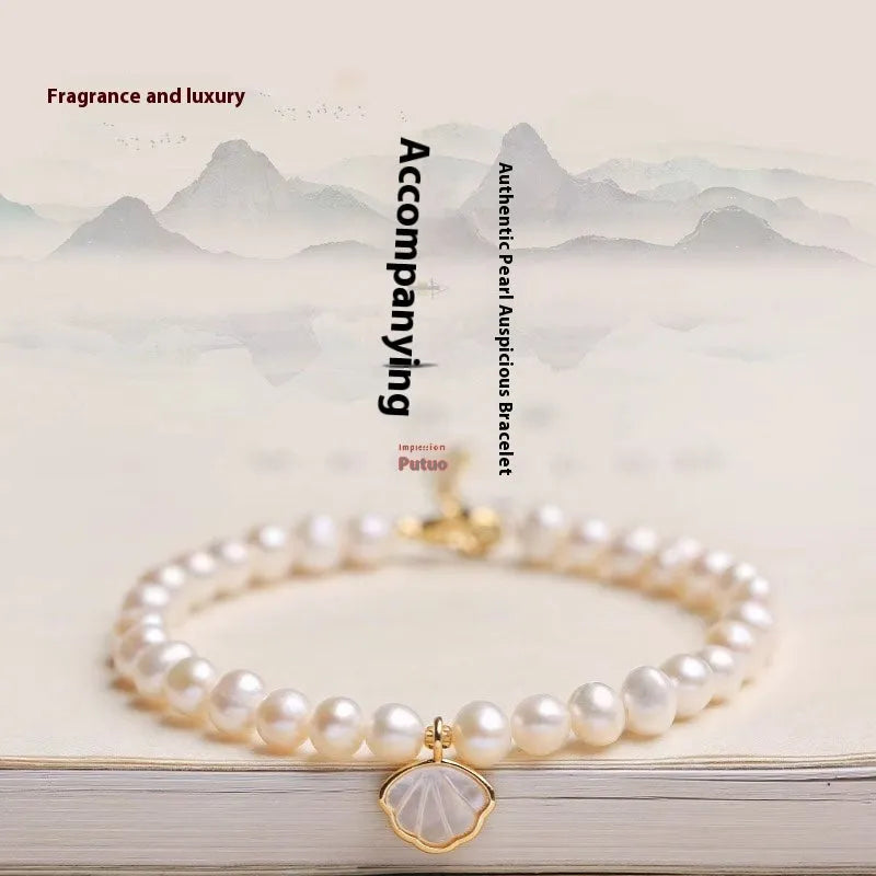 Freshwater pearl bracelet with fan-shaped shell design showing pearls on elastic or chain option
