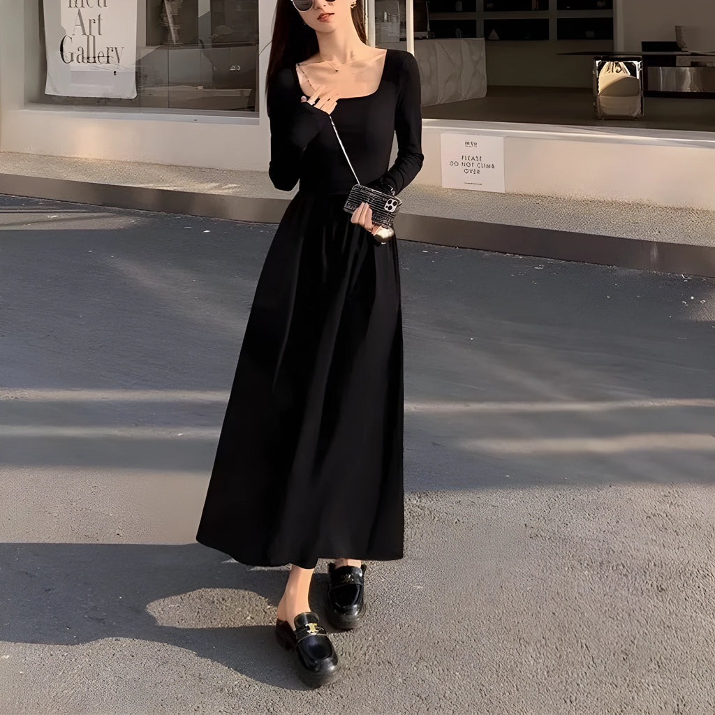 Black knitted square collar dress with long sleeves and an A-line long skirt on a model.