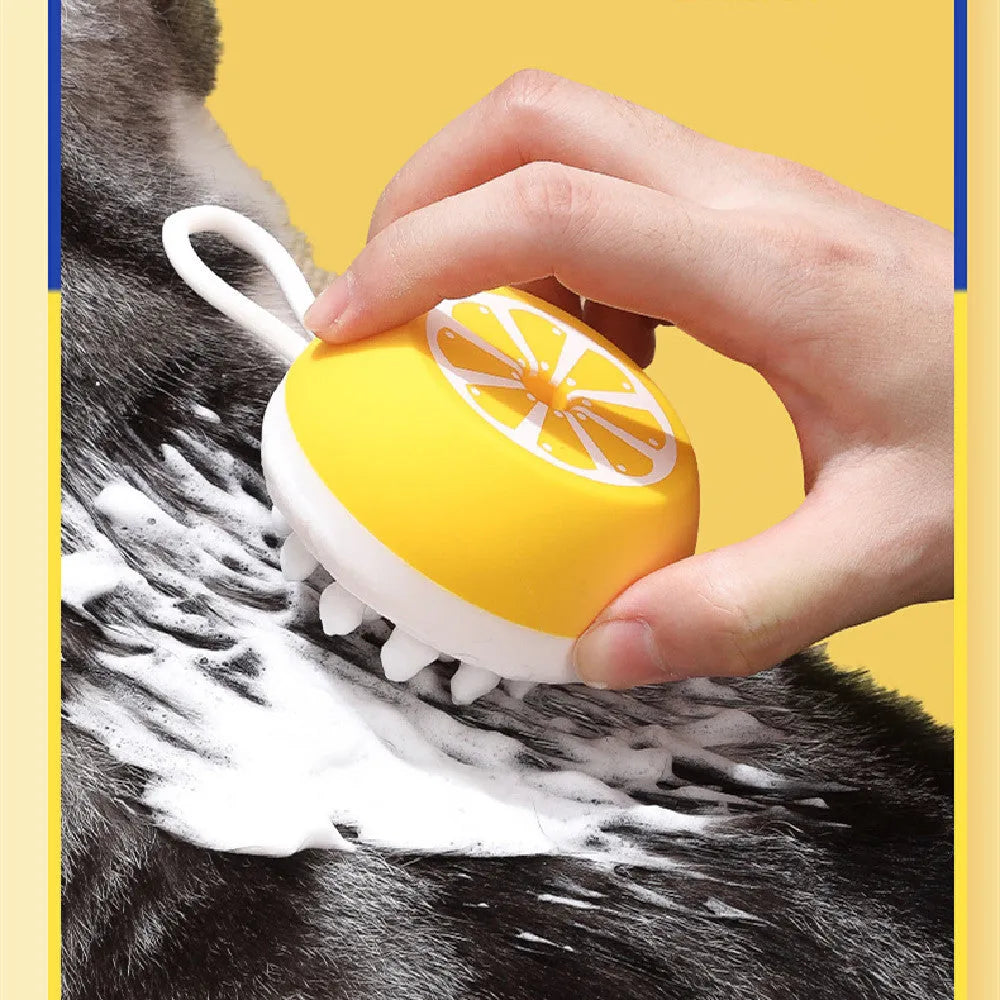 A soft silicone pet bath brush and massage comb in yellow, showing both the combed hair head and the 3D massage head.