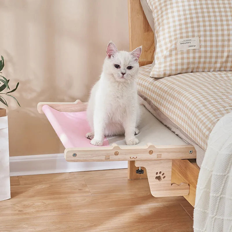 Wooden cat hanging bed hammock in a style style, mounted on a balcony railing for a cat to rest on.