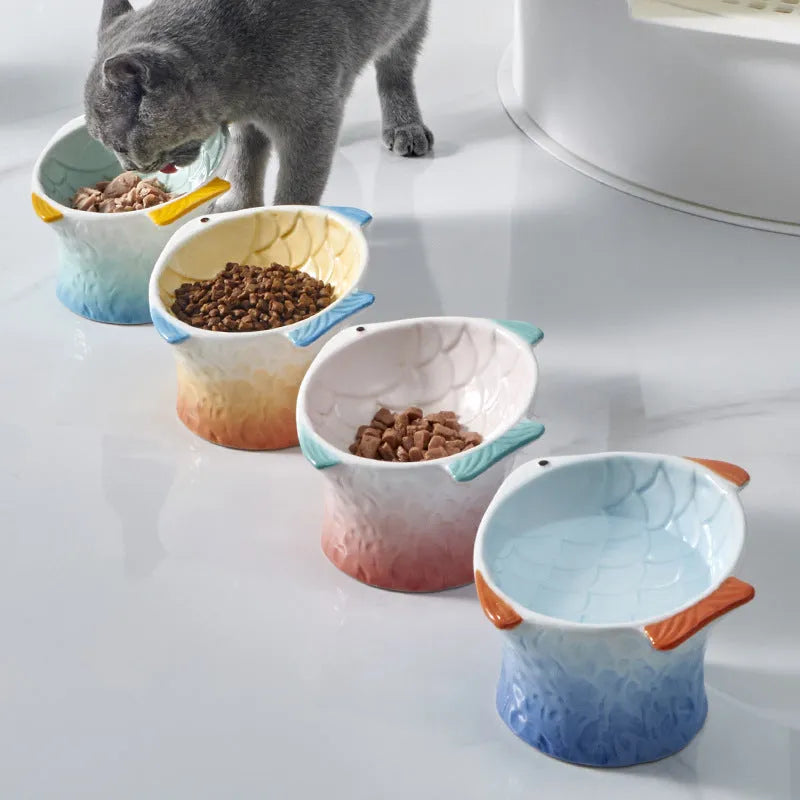 Fish-shaped ceramic cat bowls with elevated design and 15-degree tilt angle in blue, green, pink or yellow
