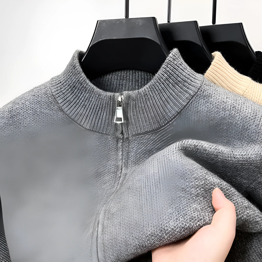 Men's black zip-up knitted cardigan with a stand collar, shown on a model.