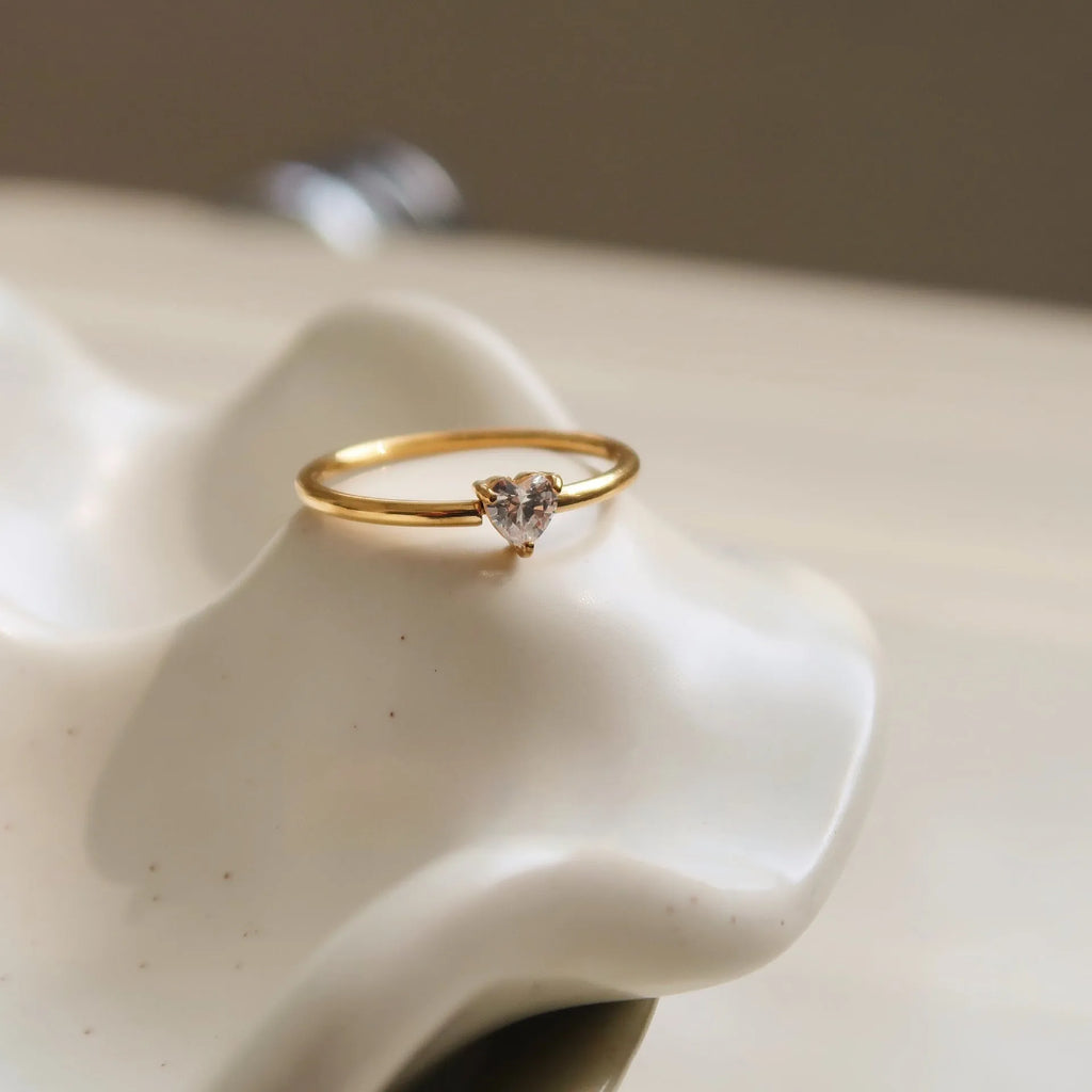 Golden heart shape stainless steel ring with electroplated finish on female hand