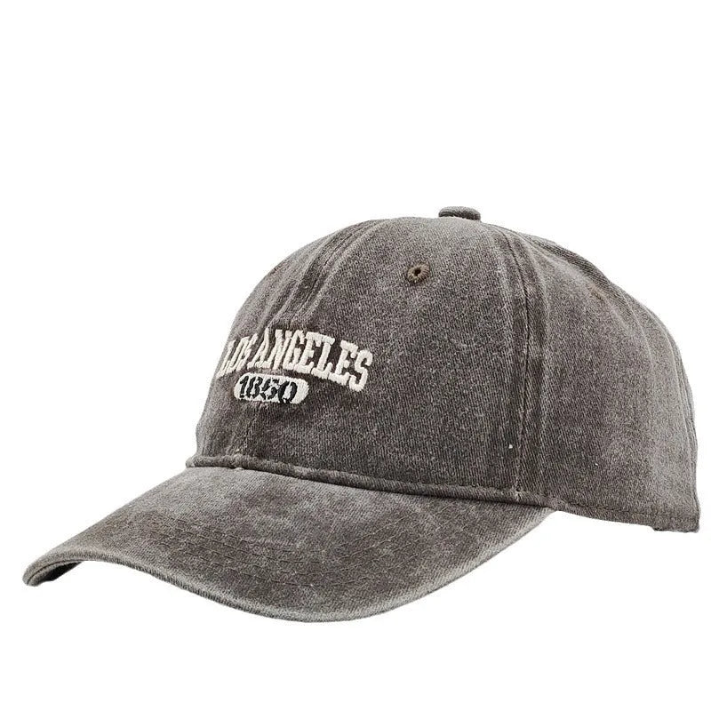 Adjustable peak cap with embroidered letters in distressed retro style, showing conical crown and 7cm brim