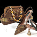 Women's pointed toe high heel shoe with matching small bag, shown in blue with a wine glass heel and rhinestone detail.