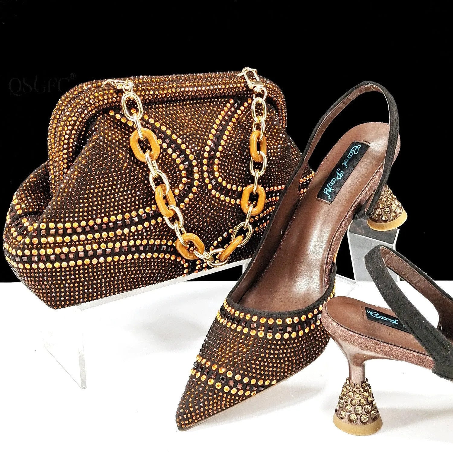 Women's pointed toe high heel shoe with matching small bag, shown in blue with a wine glass heel and rhinestone detail.