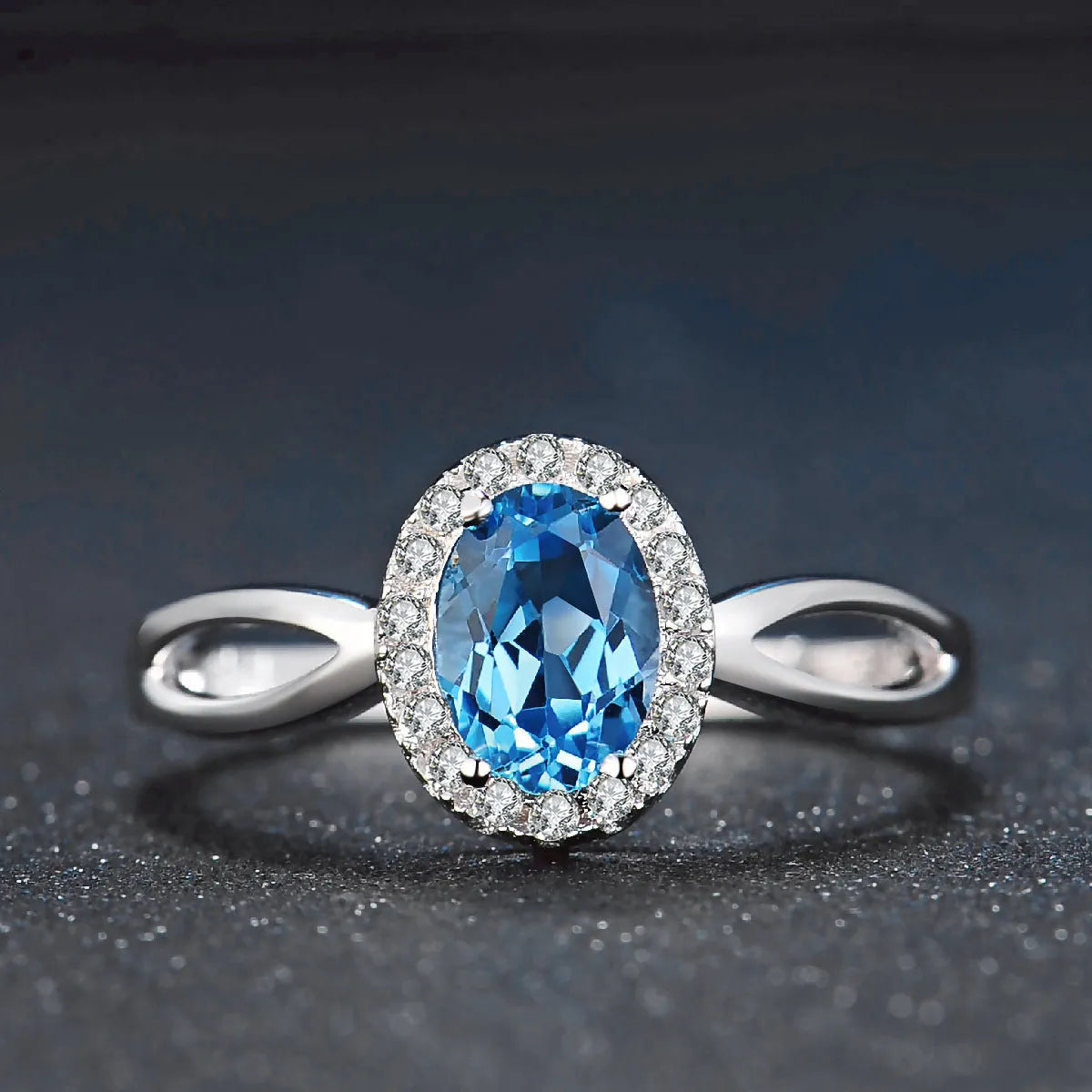 Women's sterling silver jewellery set with blue topaz gems featuring geometric earrings, ring, necklace and pendant