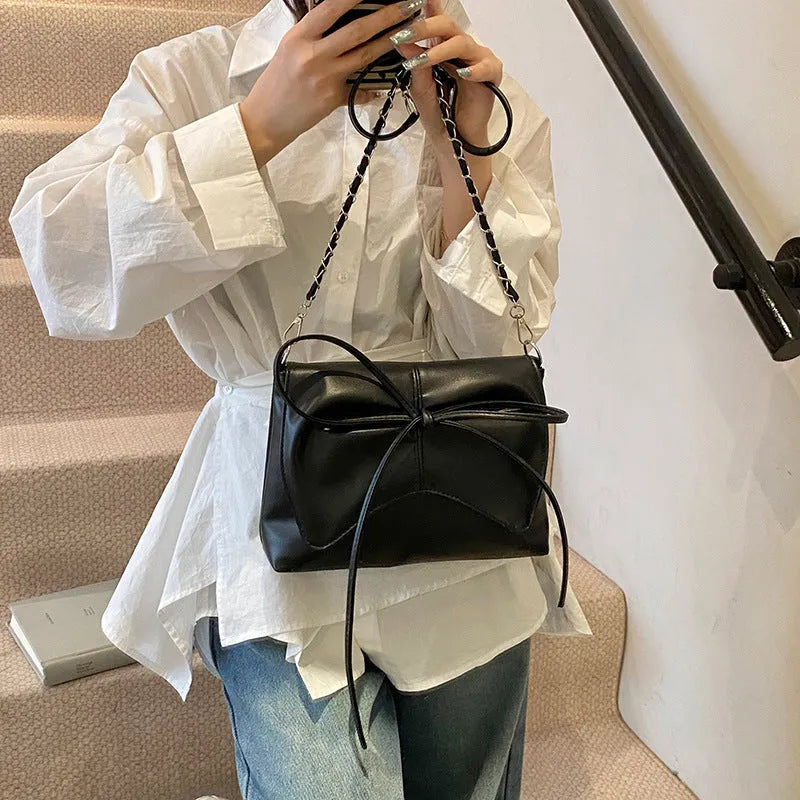 Women's horizontal square PU leather crossbody bag in black with sewing line detailing and mobile phone pocket
