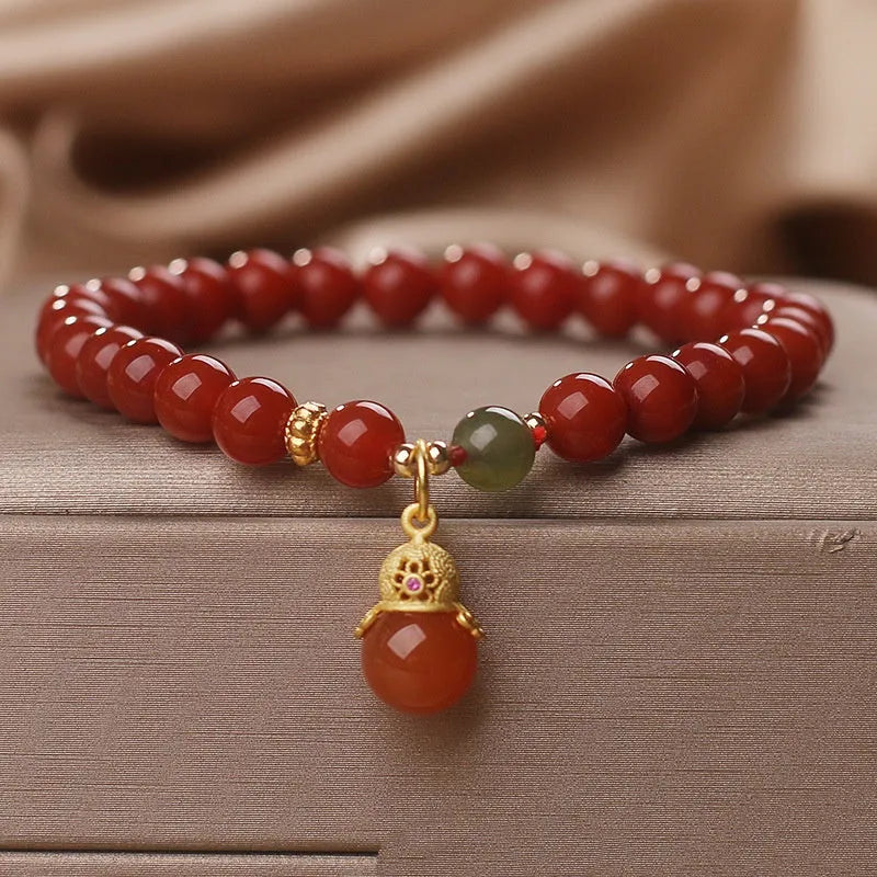Natural red agate bracelet with zodiac pendant on wrist