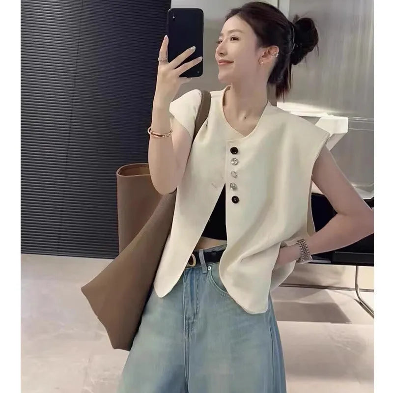 Women's loose fit vest in black with pocket detail and short length