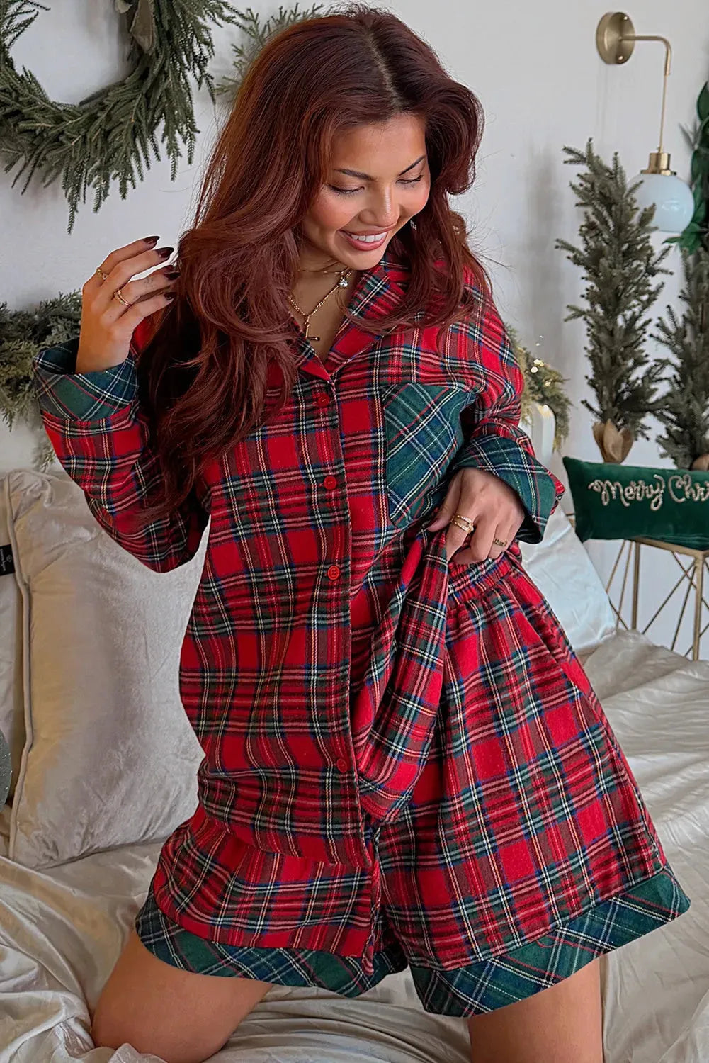 Red Christmas holiday pajama set with plaid patch detail on the long sleeve shirt and matching shorts.