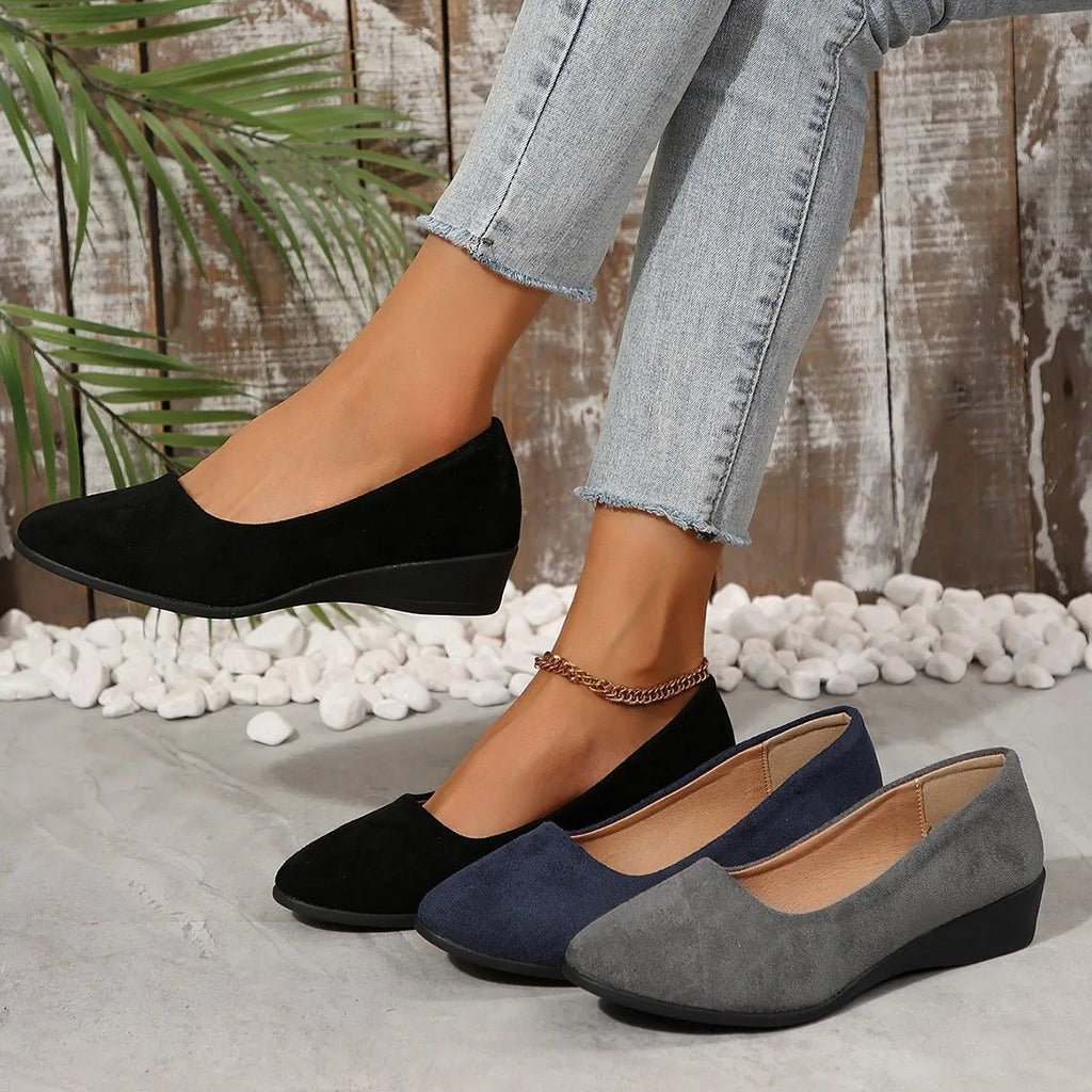 Women's low-heel suede wedge pump in light brown with a round toe and rubber sole.