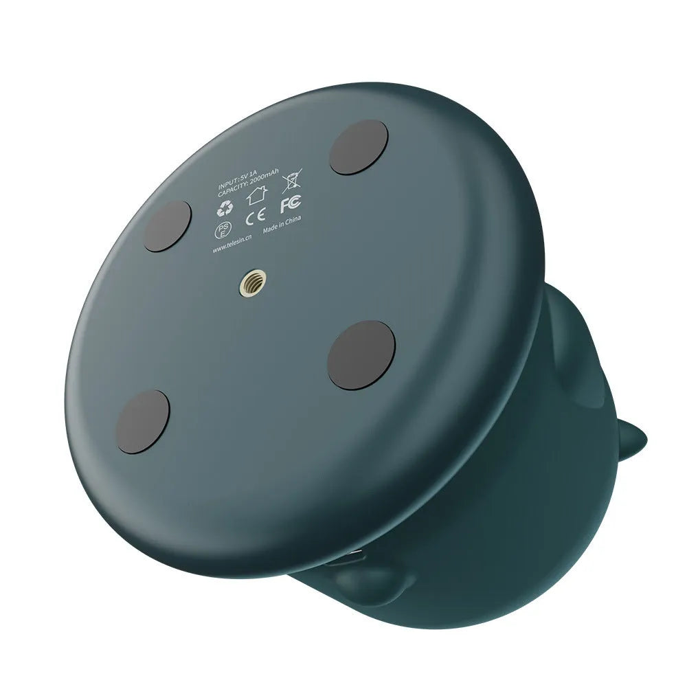 Dark green intelligent follow-up gimbal with 360-degree rotation on a desktop