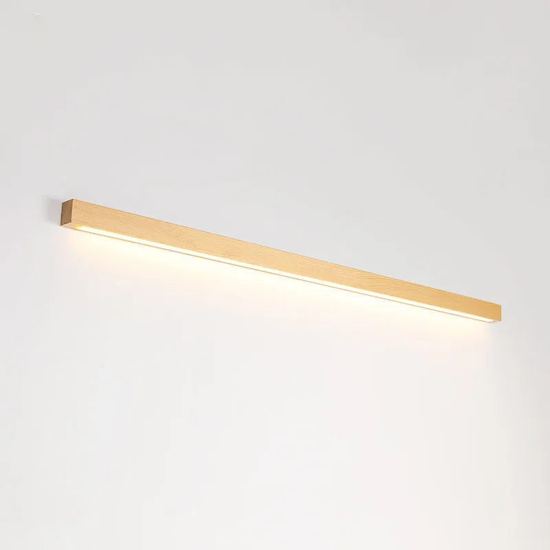 Slim walnut-colour wood and acrylic LED strip wall lamp in three length options on a white wall.