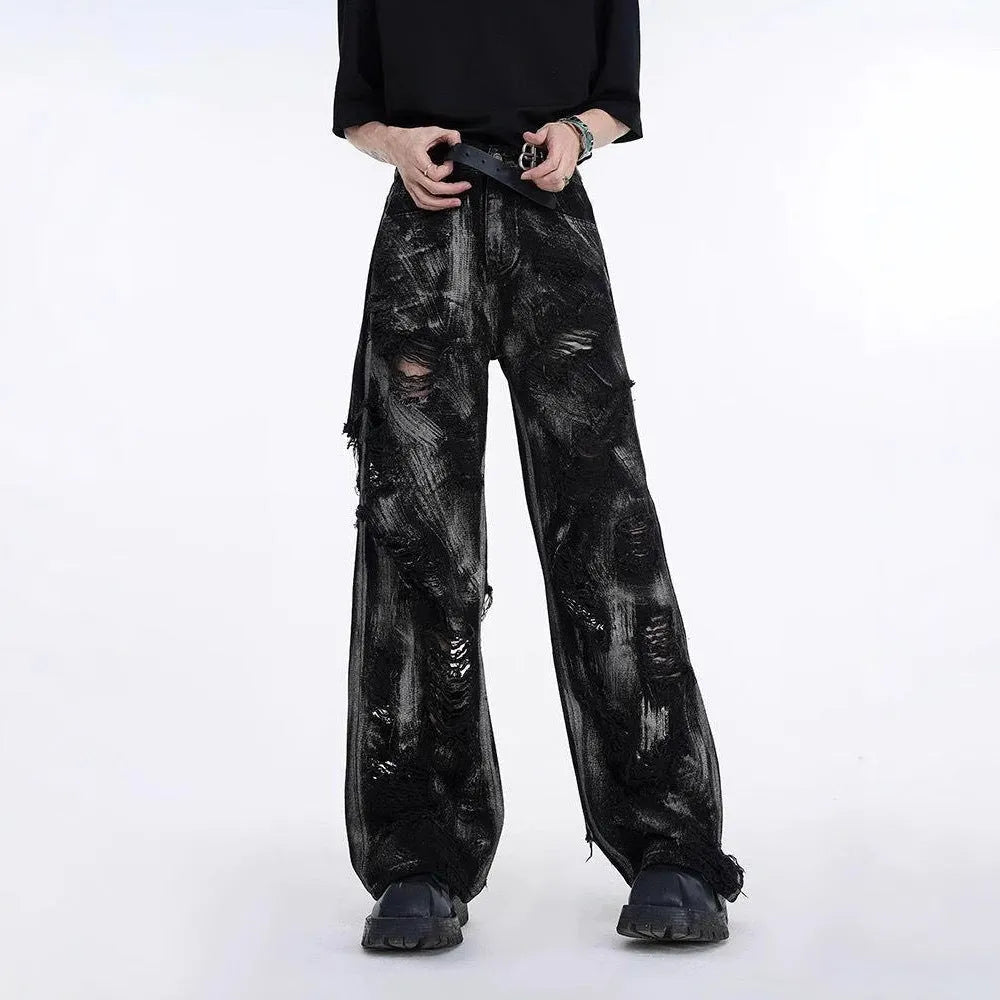 Man wearing a heavyweight washed graffiti denim jacket and matching mid waist trousers in a street style setting.