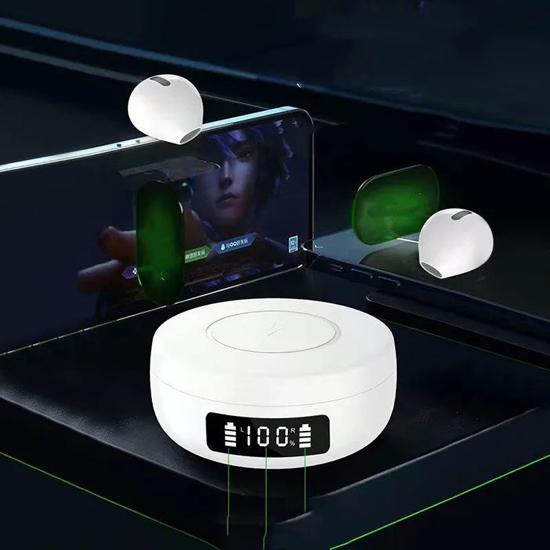 Mini black wireless semi-in-ear headphones sitting in their open white charging case on a table.