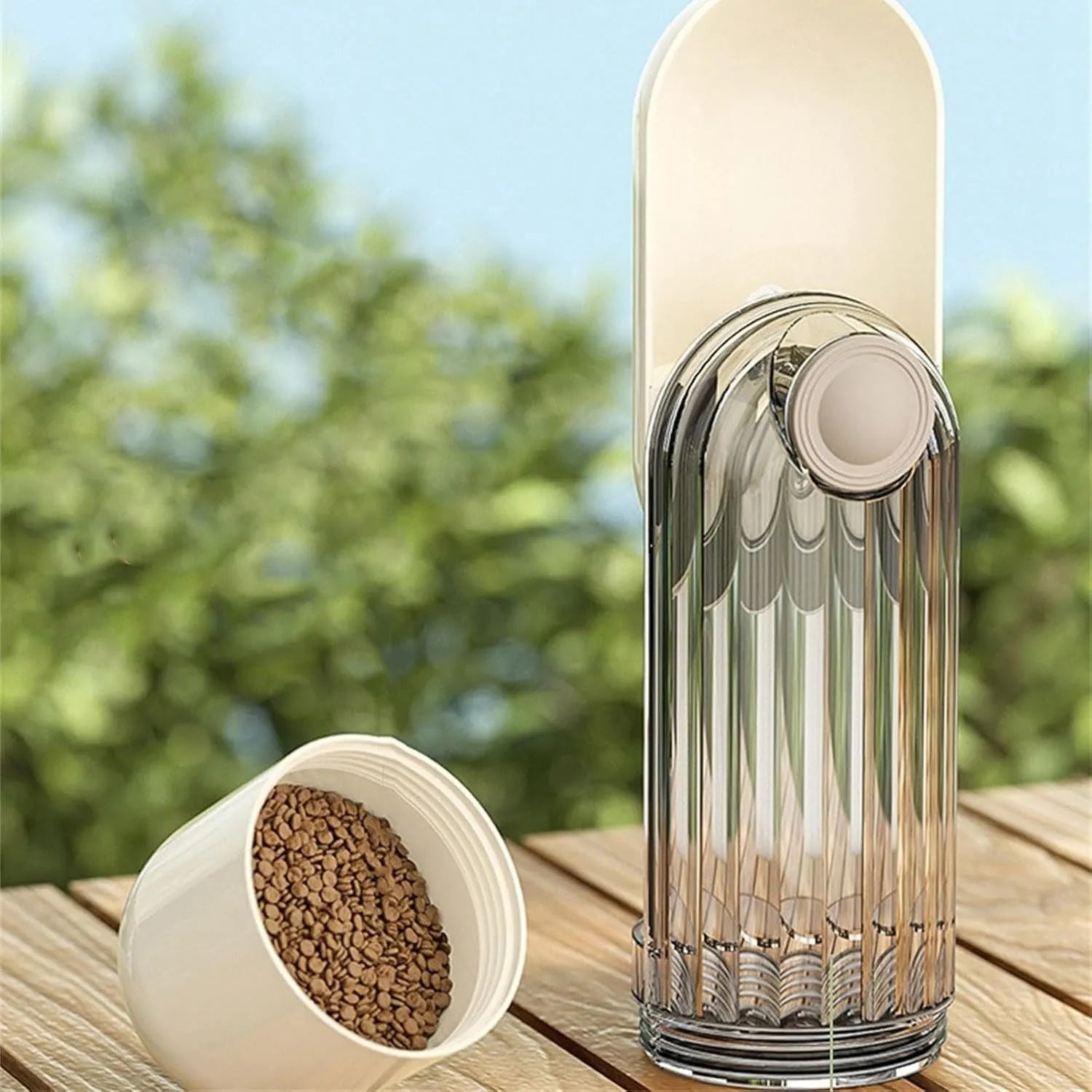 Beige and green foldable dog water bottle with integrated food container at the base
