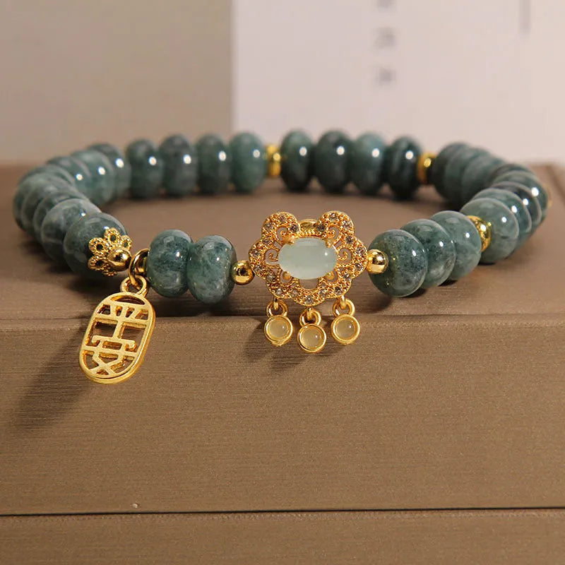 Natural emerald jade abacus bead safety lock style bracelet on women's wrist, alloy frame, green gemstone beads