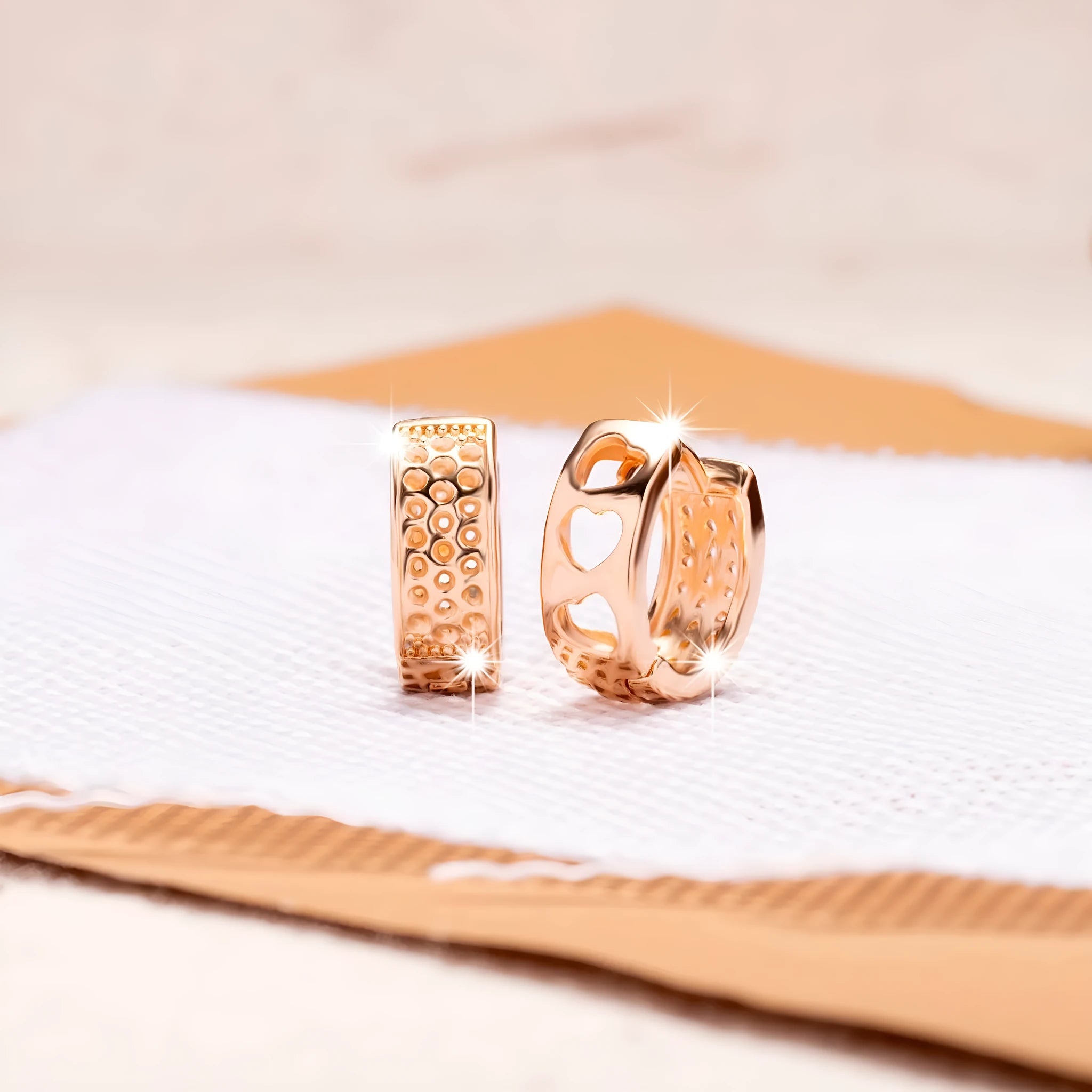 Rose gold hollowed-out heart-shaped circular earrings with electroplated finish