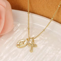 Gold-coloured Virgin Mary and cross pendant necklace on a chain.