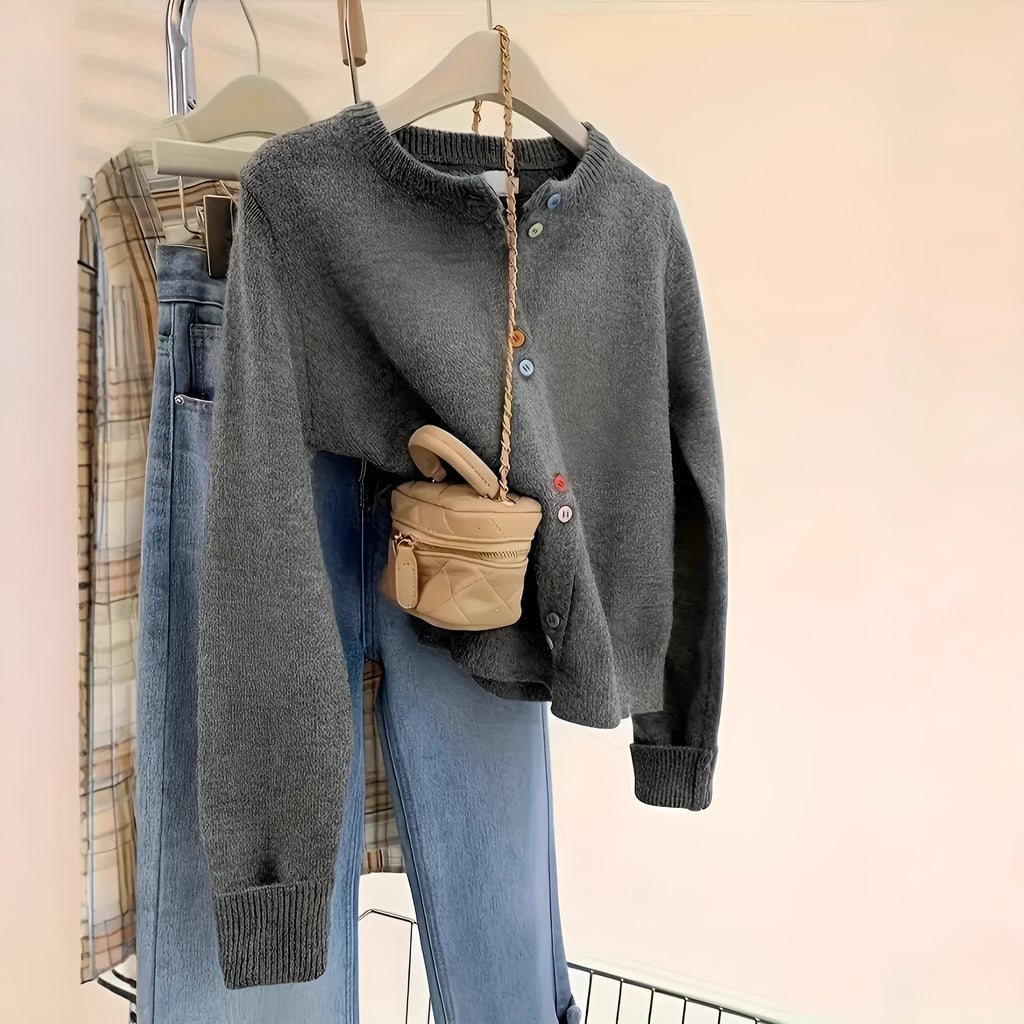 Dark grey women's button-front polyester cardigan on a hanger.