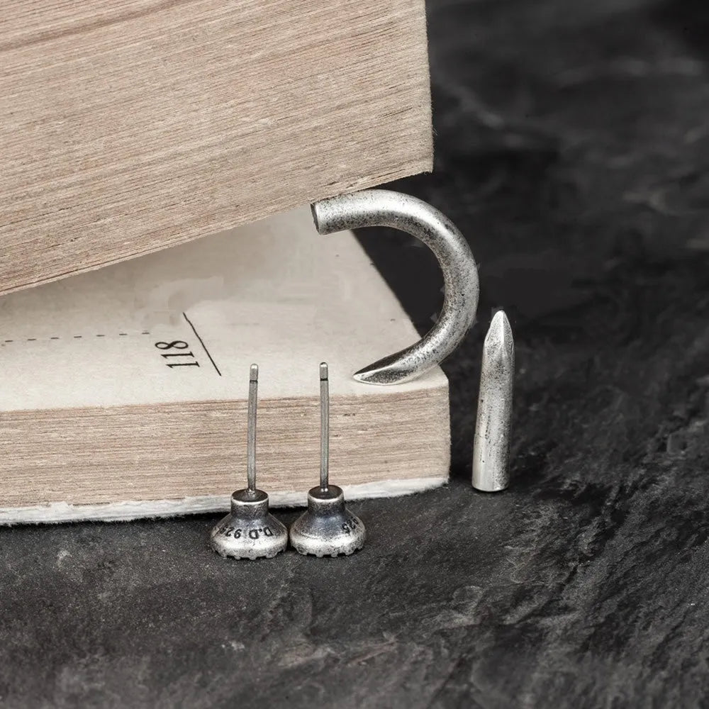 Sterling silver nail stud earrings in straight and curved punk styles on ear hooks