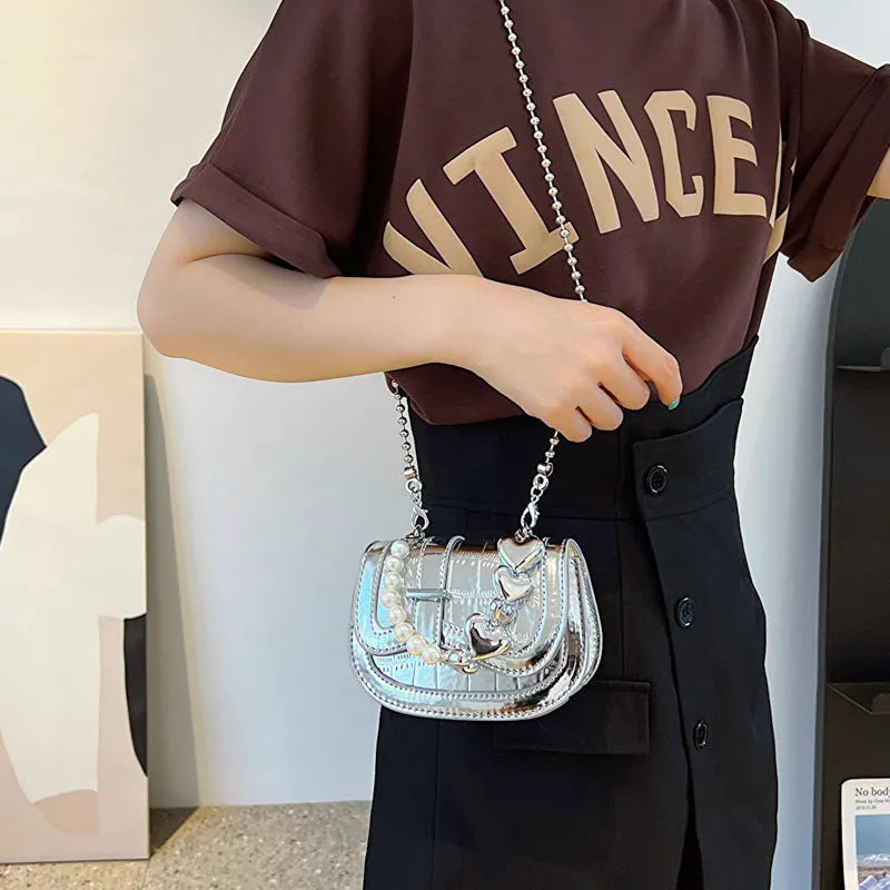 Mini crossbody bag in PU leather with mobile phone pocket, shown in silver colour with horizontal square design