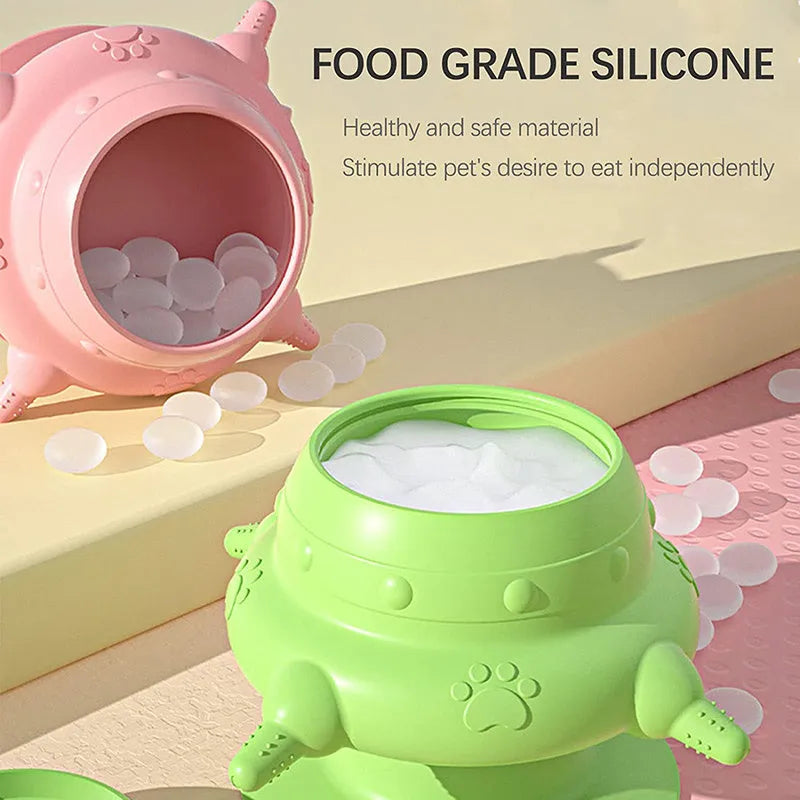 Pink silicone pet nursing bottle with bionic breast-shaped pacifier on a flat base, with three additional pacifiers.