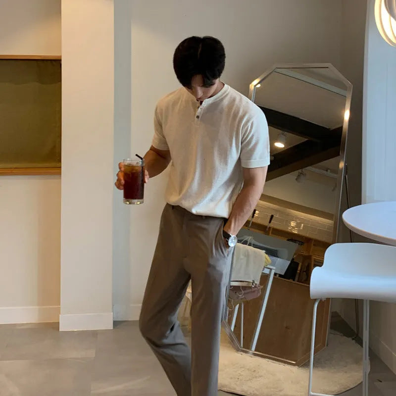 Man wearing a thin black slim-fit knitted short-sleeved shirt.