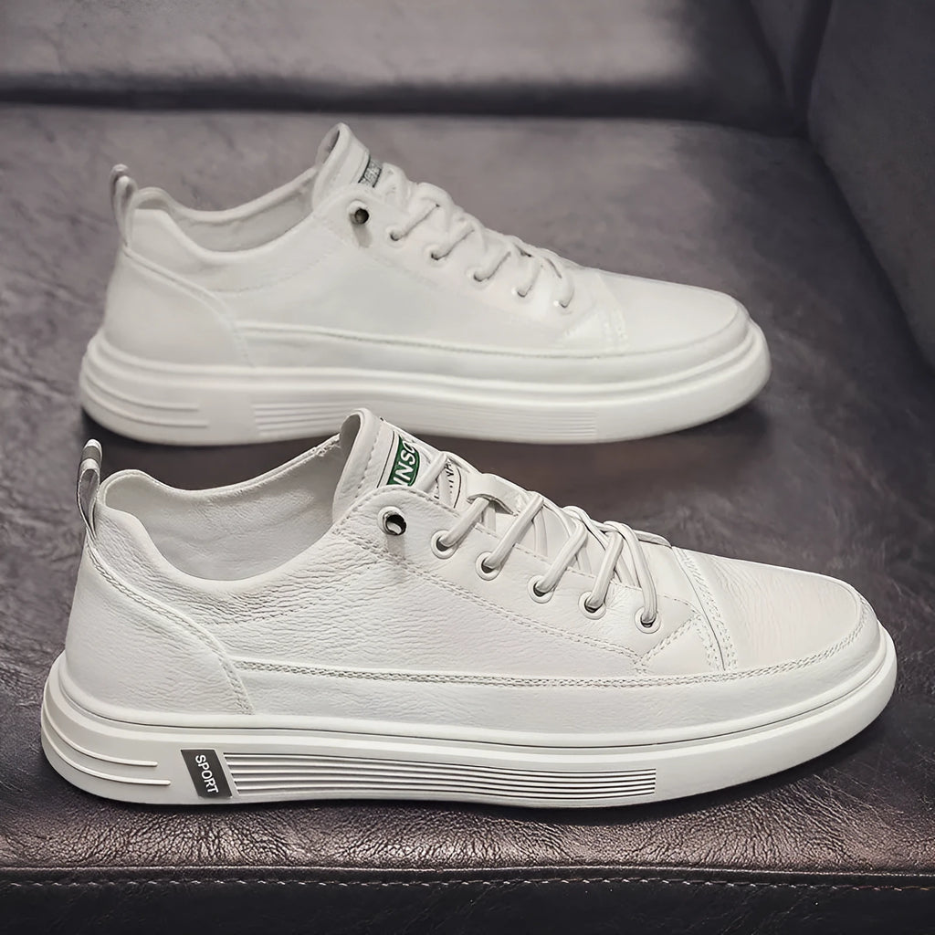 Men's white casual summer shoes with round toe and flat low heel on a plain background.