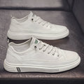 Men's white casual summer shoes with round toe and flat low heel on a plain background.