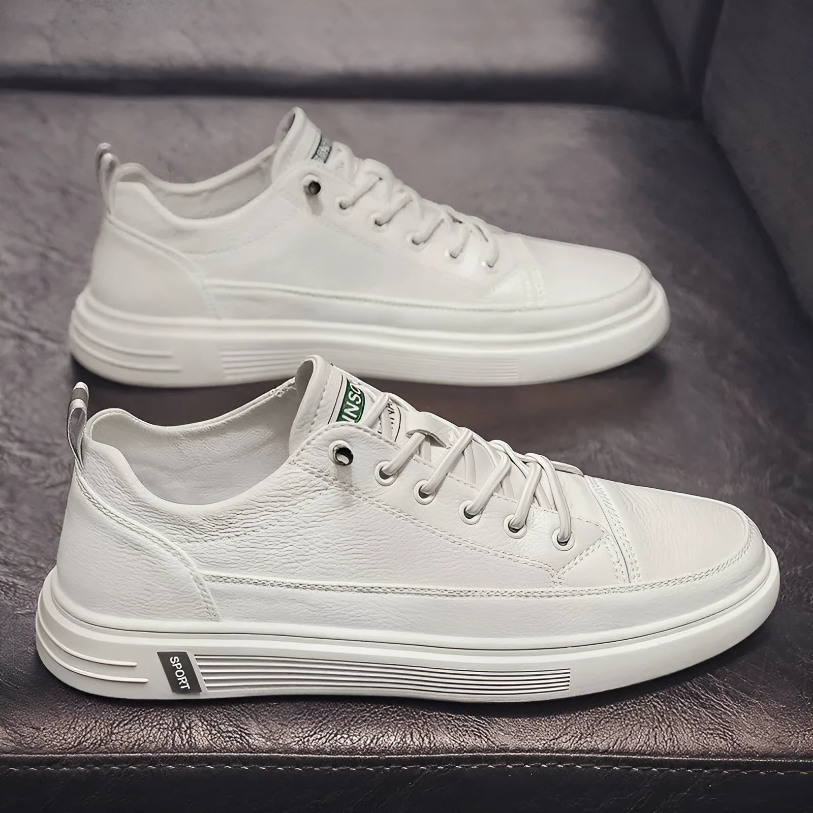Men's white casual summer shoes with round toe and flat low heel on a plain background.