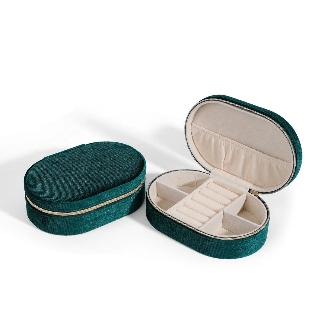 Oval velvet jewellery box in lake blue colour with flannel interior, shown with rings inside.