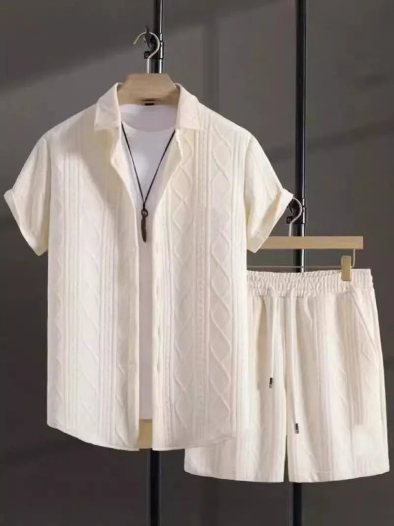 Men's black and white Jacquard print short sleeve suit with matching shorts on a hanger.
