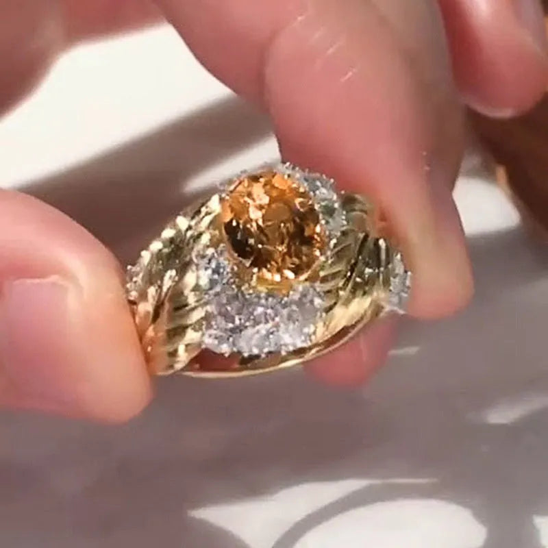 Women's gold-coloured copper ring with embossed feather pattern and yellow zircon stone in geometric setting