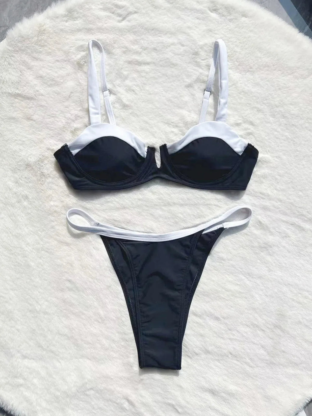 Low waist black women's bikini bottoms with stitching split, nylon spandex, front view