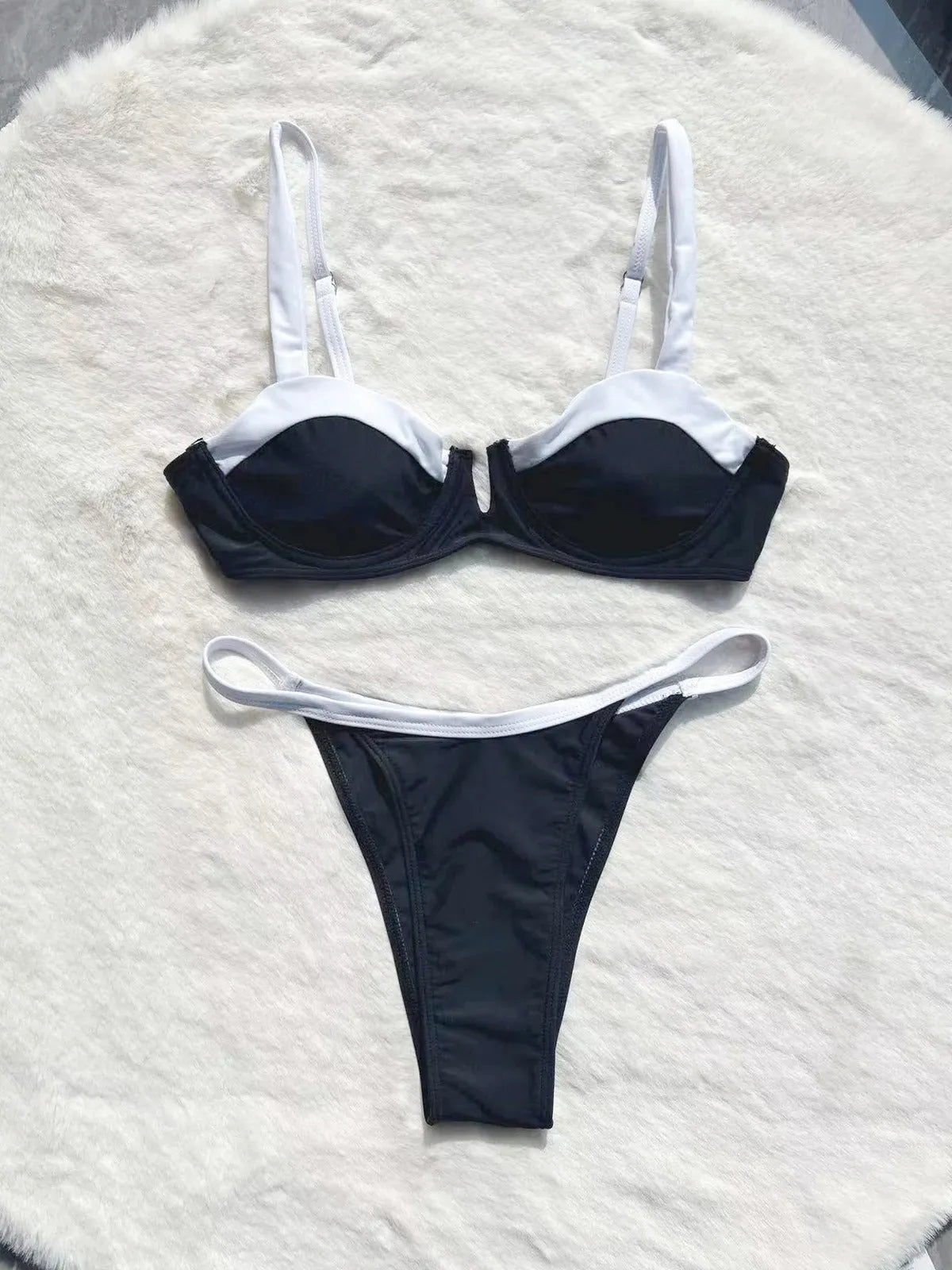Low waist black women's bikini bottoms with stitching split, nylon spandex, front view