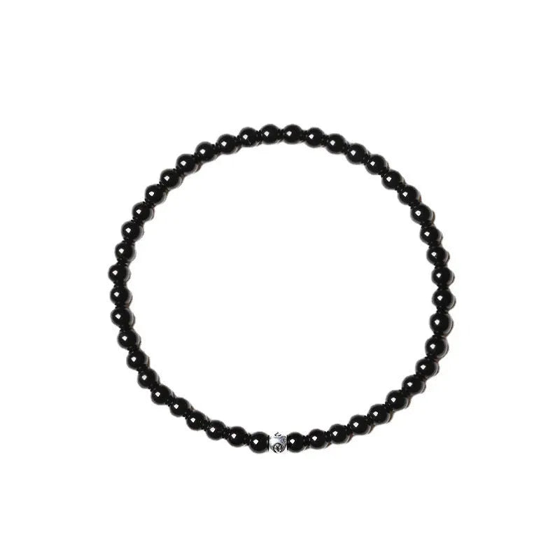 Geometric unisex bracelet with black obsidian, blue san, and cut black agate 4mm beads.