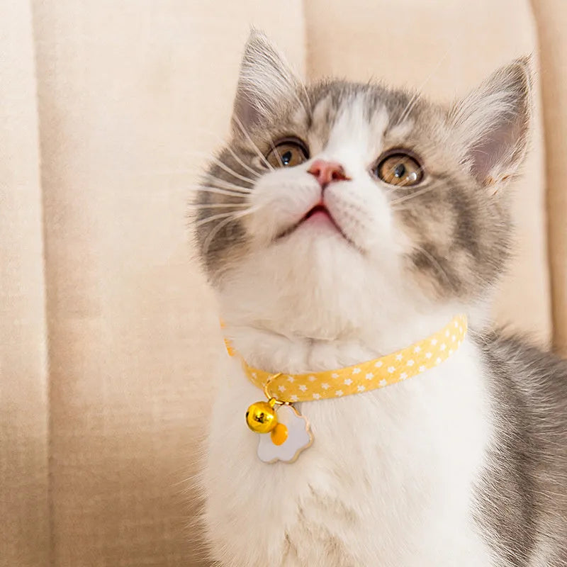 Adjustable cat collar with bell pendant and bow tie accessory in green, pink, or yellow colours