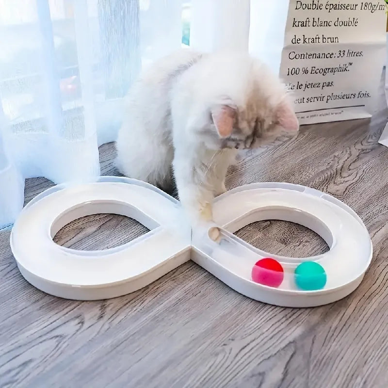 Blue and white cat toy set with a turntable track ball and a teasing stick on a floor.