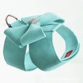 Pink microfiber dog chest strap with a large white bowknot, showing adjustment buckle and D-ring.