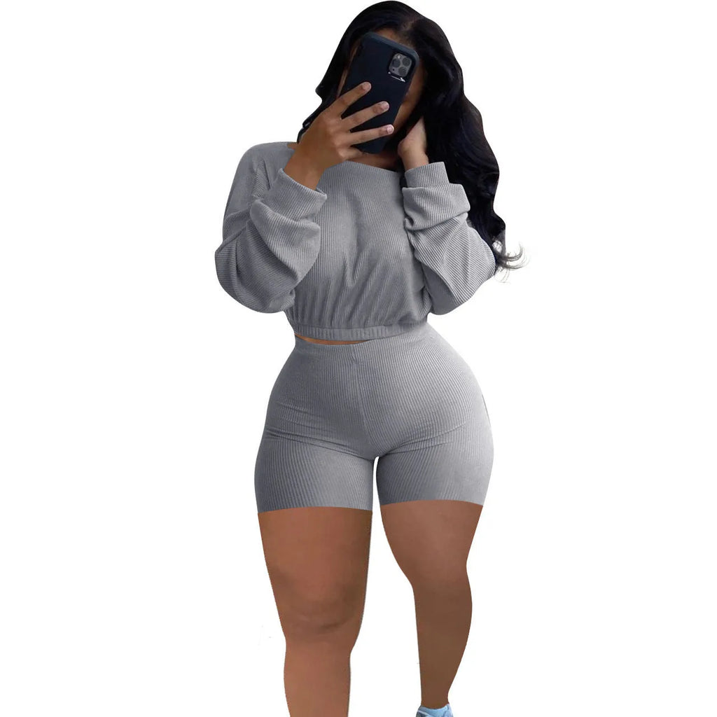 Women's off-the-shoulder long sleeve top and shorts two-piece set in a solid colour with a sunken stripe pattern.