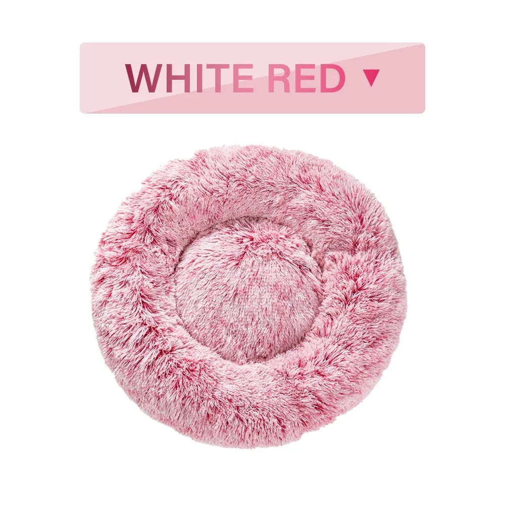 Fluffy donut-shaped dog bed in long plush fabric, shown in a light grey colour without a zipper.
