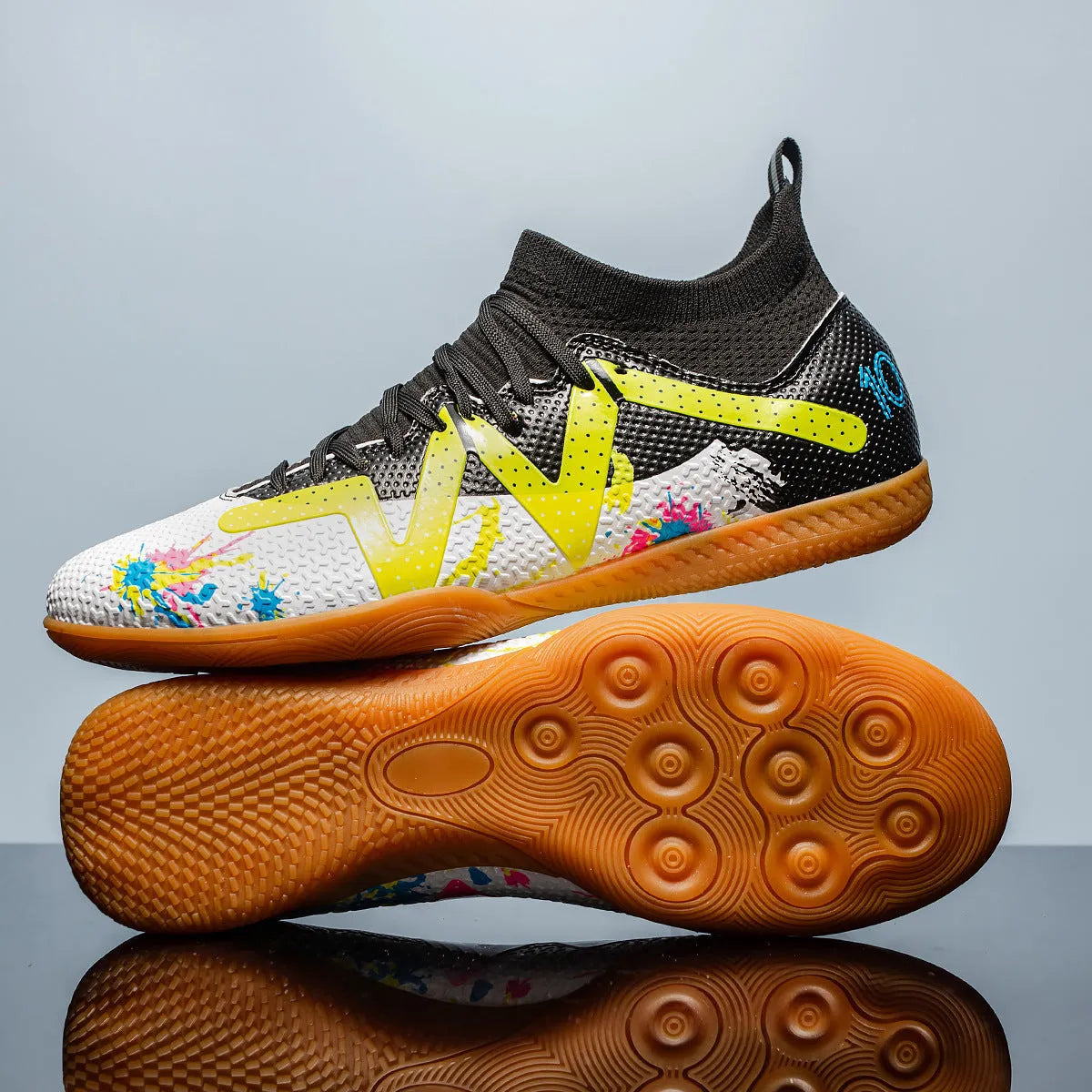 Adult low-top football boots with a PVC upper and rubber studded outsole, shown in black and yellow.
