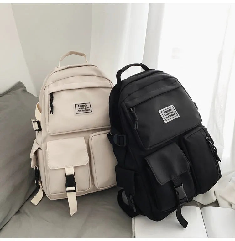 Black and white student nylon backpack with laptop compartment and outer pockets.