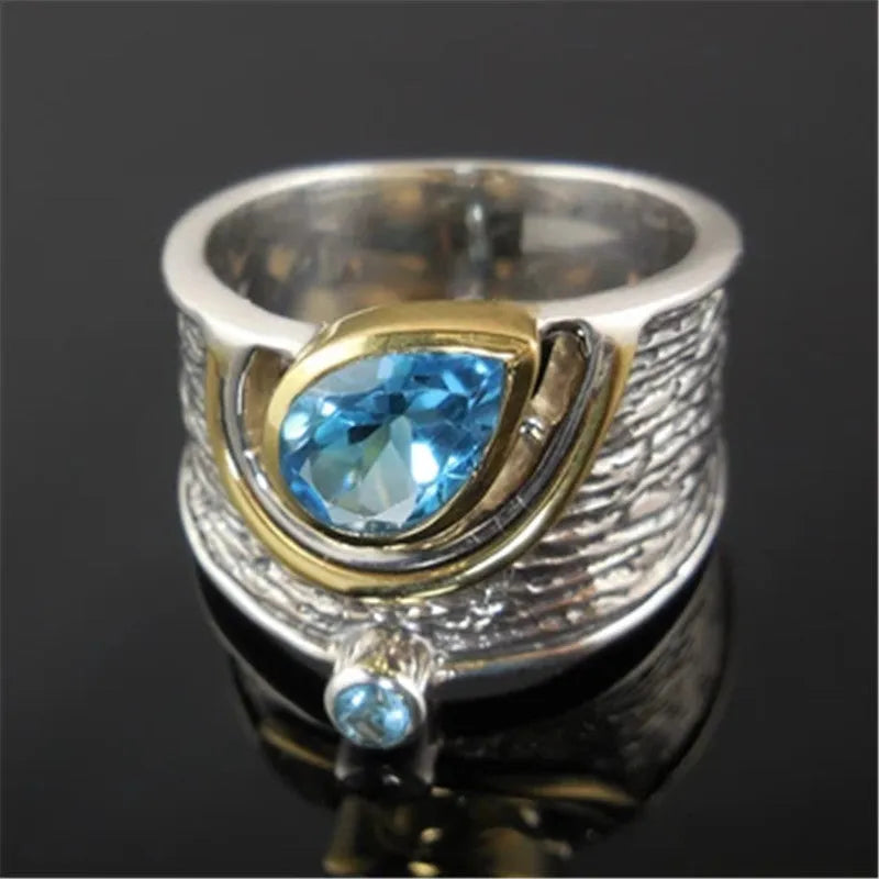 Blue rhinestone zircon drop shape ring on a white background, showing Chinese-inspired alloy design.
