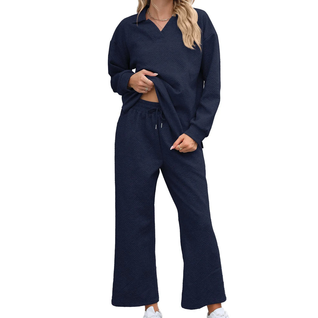 Women's solid colour knit suit with long sleeve V-neck sweater and elastic waist cropped trousers.