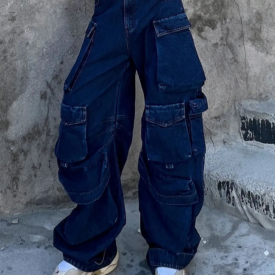 Dark blue distressed wide-leg women's jeans with a high waist and multiple pockets on a hanger.
